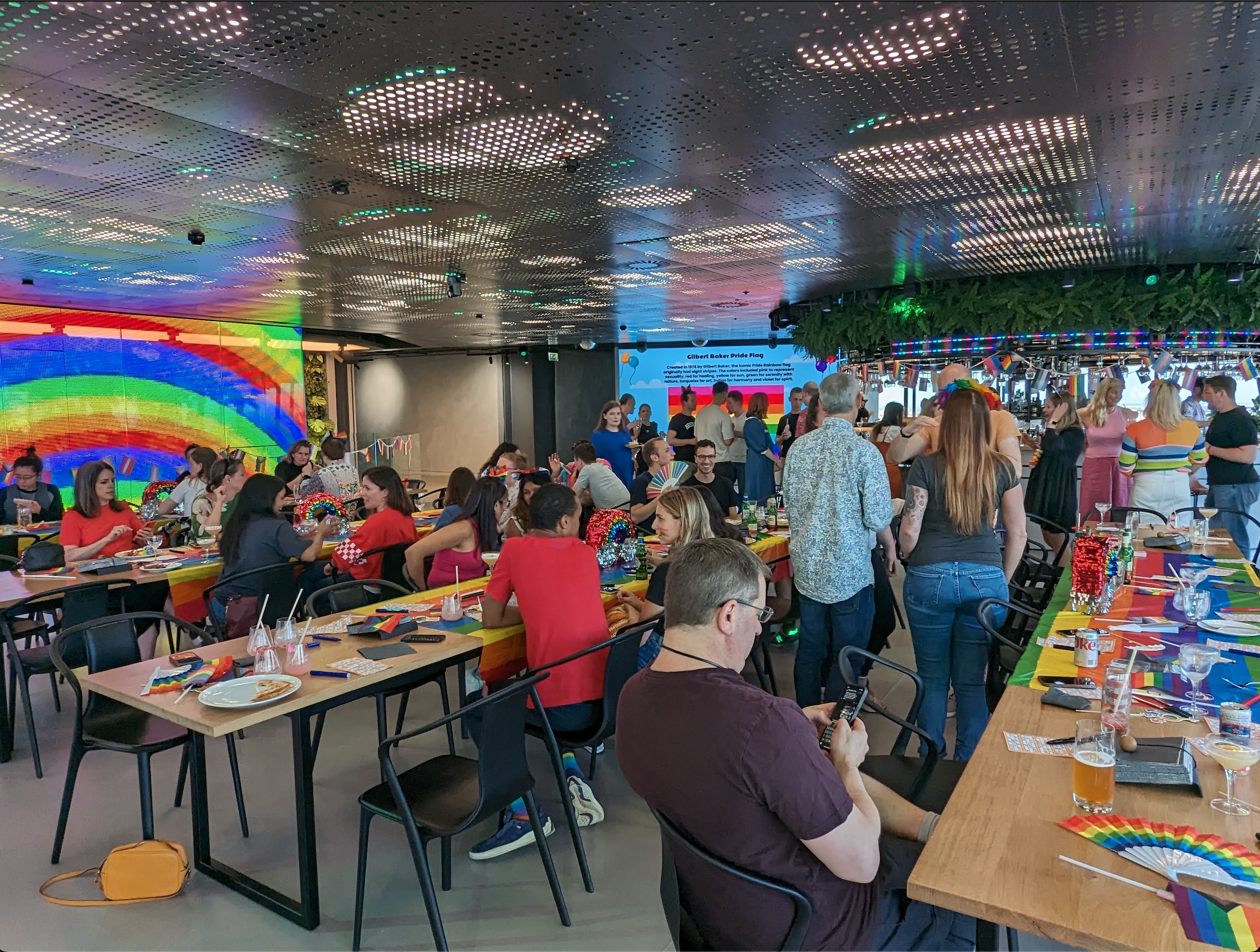 Pride social in breakout area with everyone in the breakout space talking and socialising